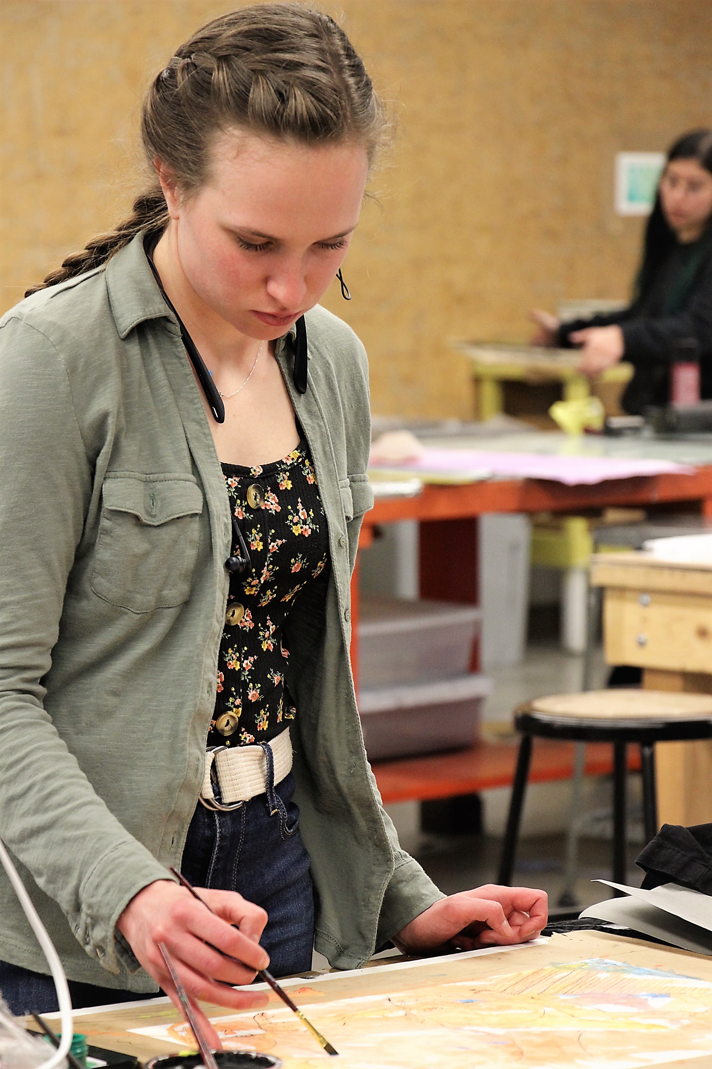 A student working on painting and printmaking techniques