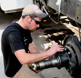 Student working on vehicle wheel