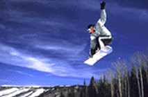 Snowboarder jumping off mountain