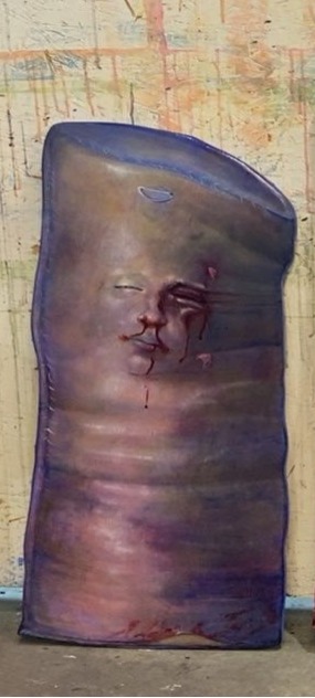 blue punching bag with a woman's face