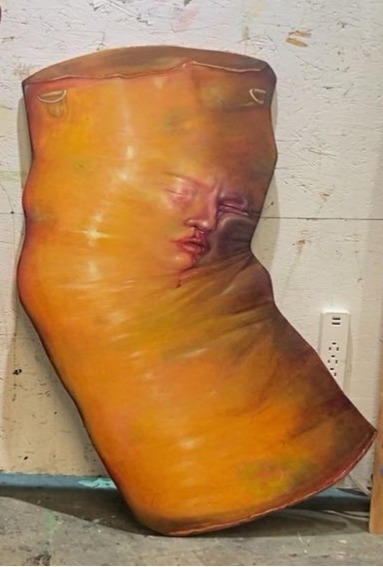 yellow punching bag with a woman's face
