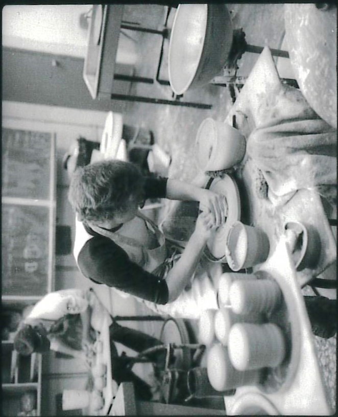 Old photo of mesa college studnet throwing pots in the pottery studio