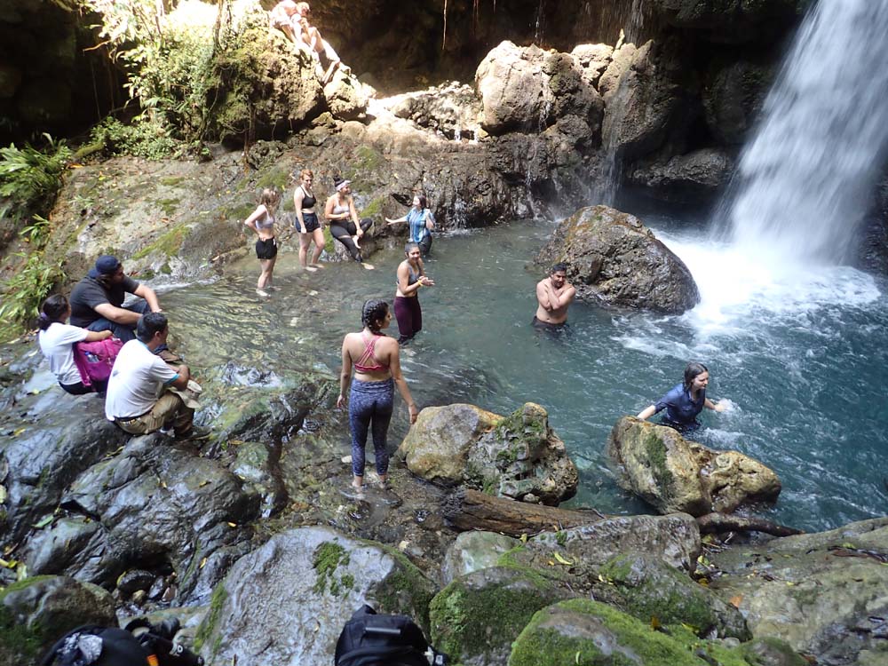 Image of students in peru exploring one of the waterfalls