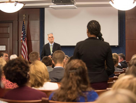Speaker addressing a woman in the audience