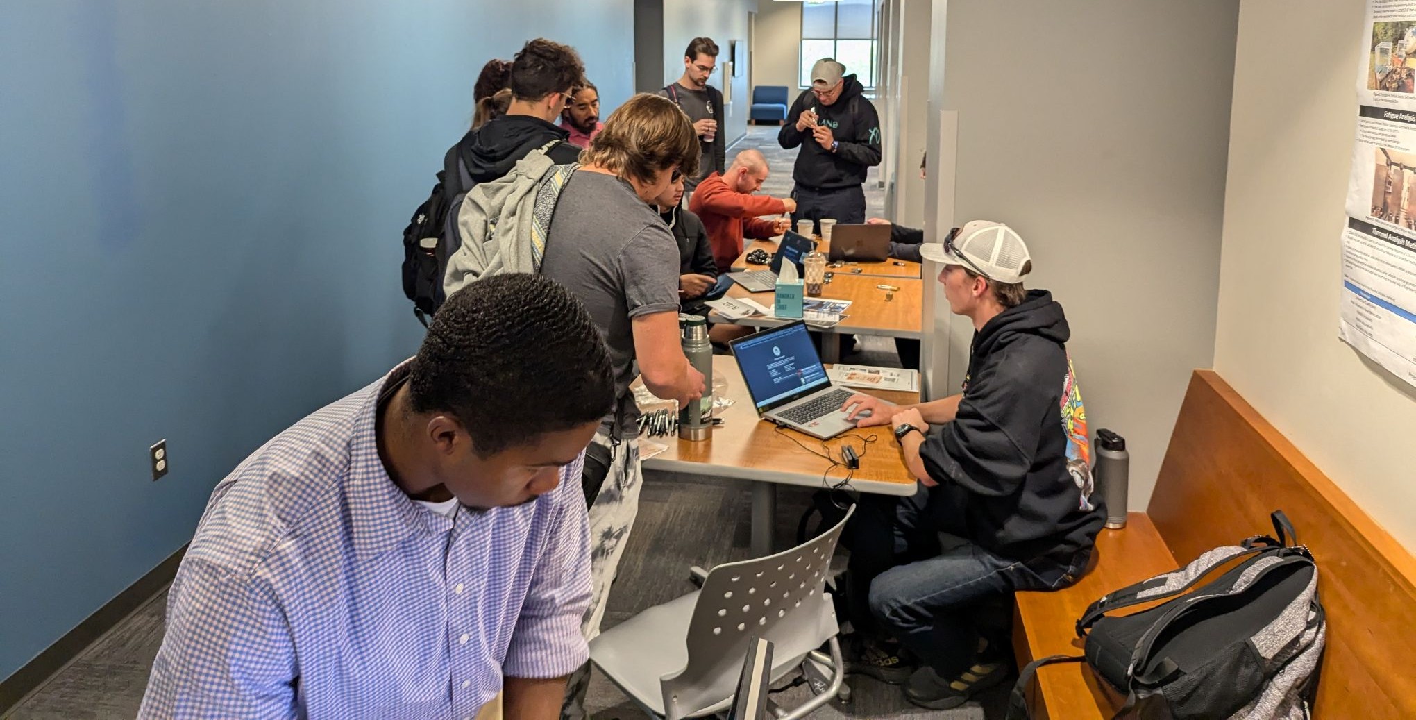 Cybersecurity students working on laptops.