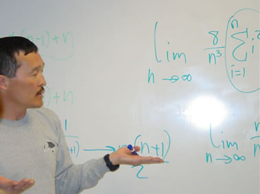 Professor Edward Bonan-Hamada explaining problem on whiteboard
