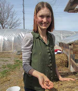 Student Nora Oviatt holds red wiggler worms.