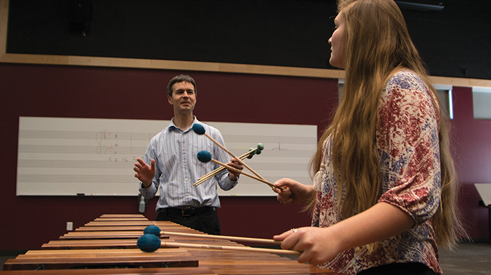 Darin Kamstra works with percussion student Autumn Kelly