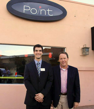 Student and President Foster standing outside of the original Point location.