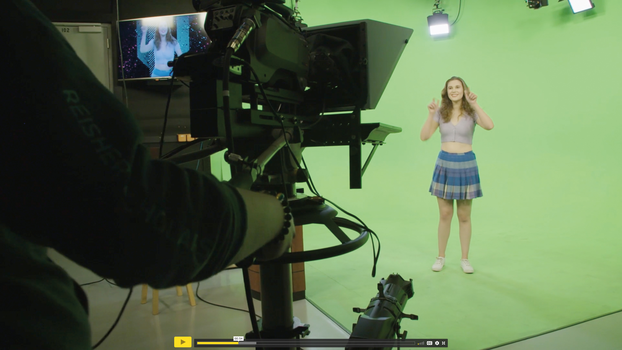Actress preforming in front of a green screen and camera