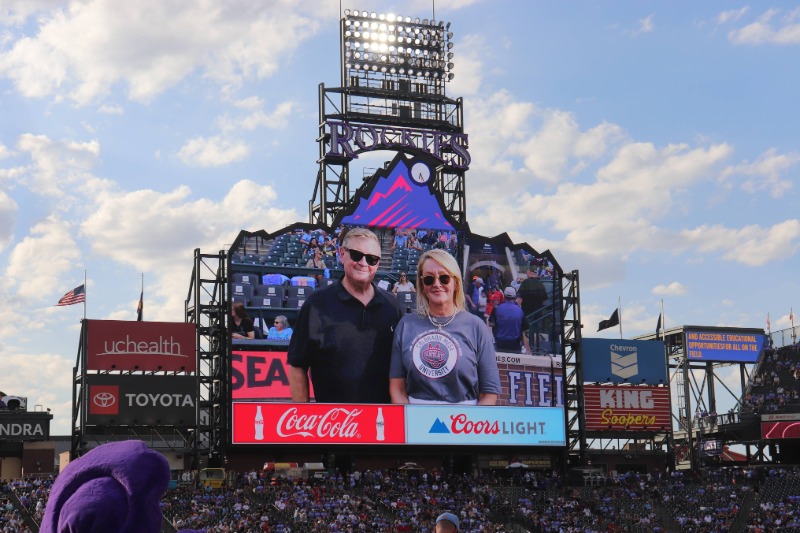 CMU Board of Trustee Kasia Iwaniczko-Macleod on the big screen at Coors Field