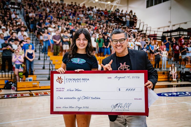 Free semester of tuition winner with SVP Student Services Dr. Montoya