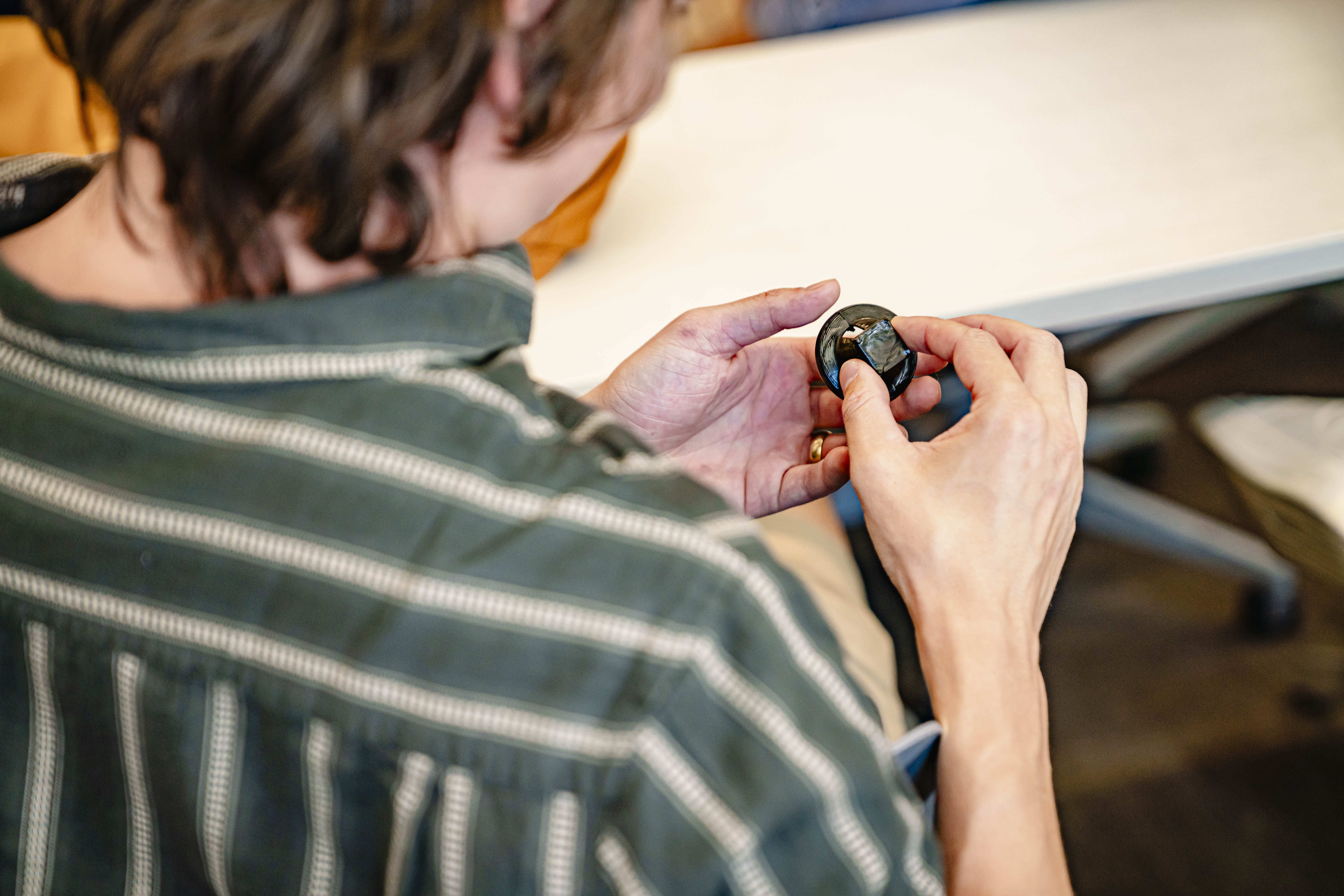 A student holds the first object Chuck Hull ever 3D printed