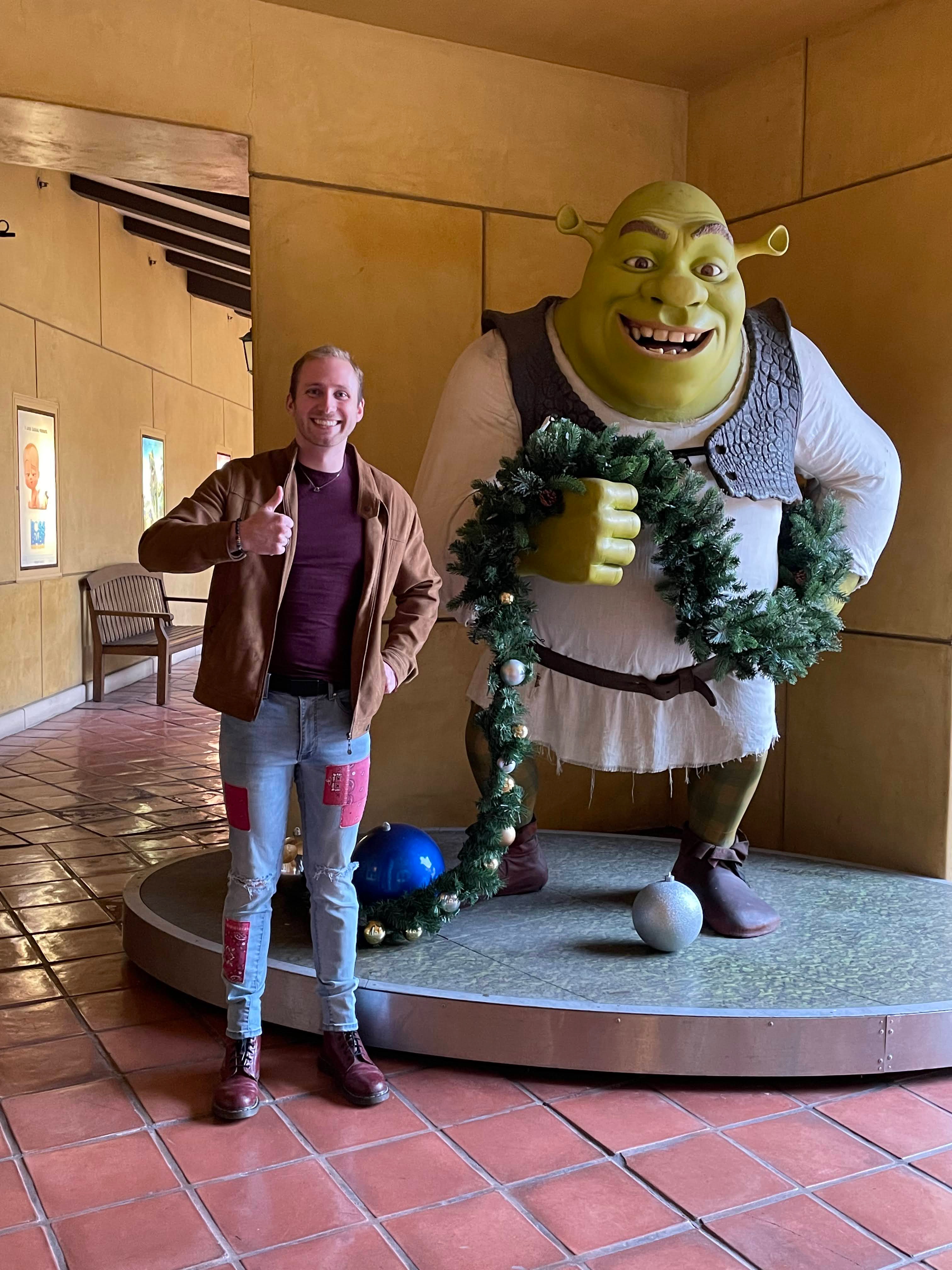 Joey strikes a pose with Shrek at DreamWorks