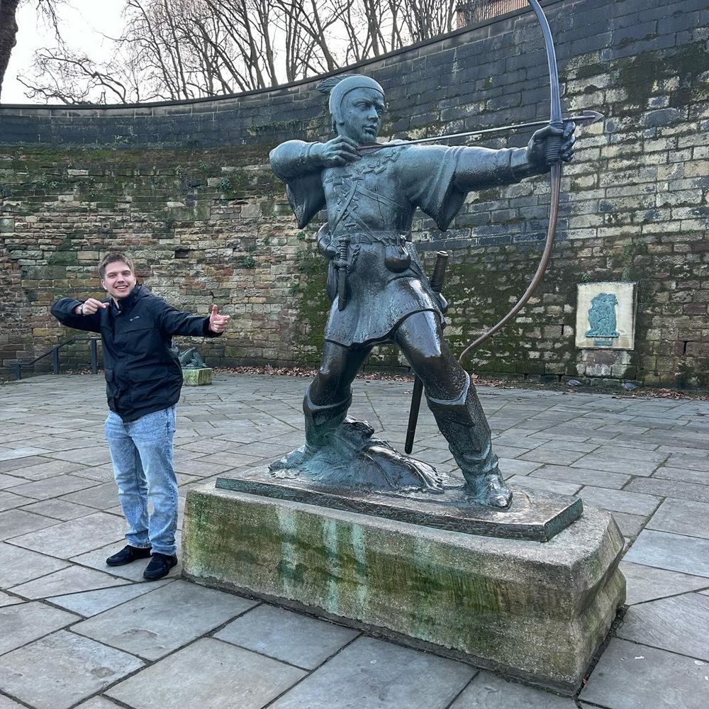 Jace in front of the Robinhood statue.