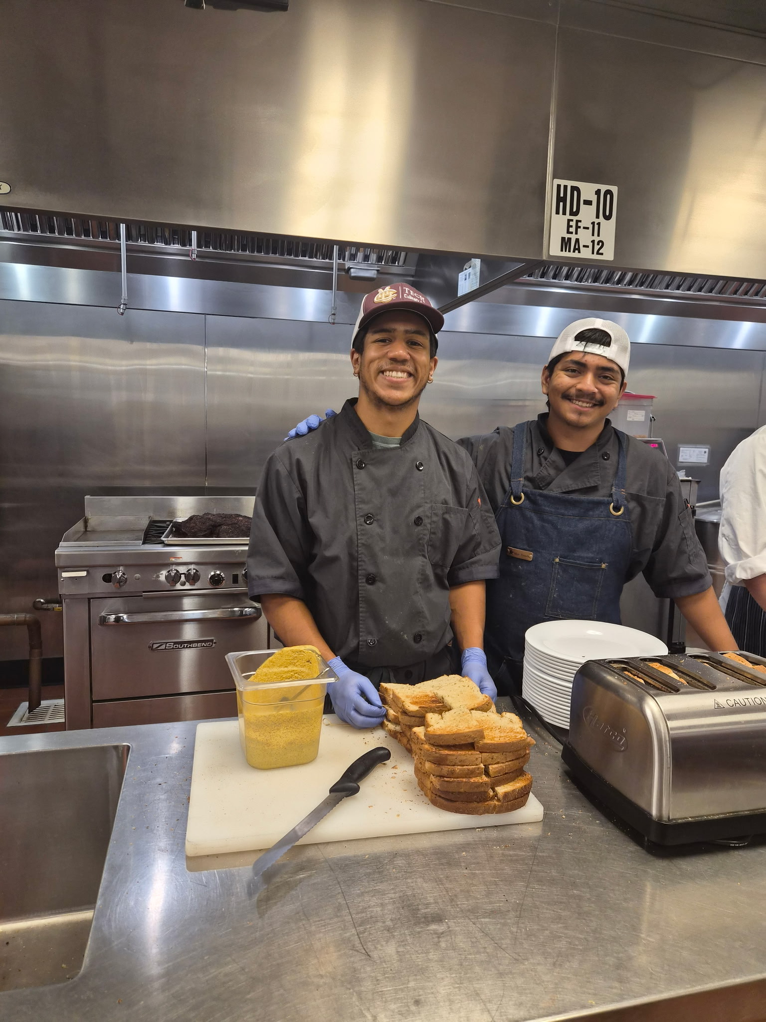 Culinary apprentices prep in the kitchen.